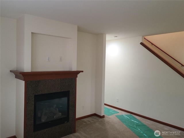 501 N 105th St Unit A, Seattle, WA 98133 - unfurnished living room with carpet flooring, a glass covered fireplace, and baseboards