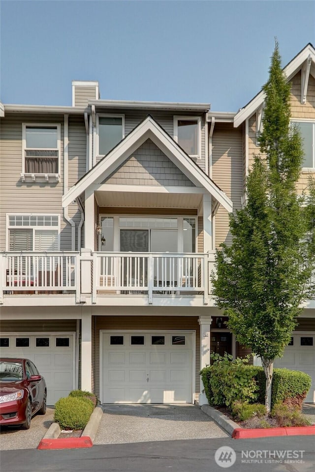23120 SE Black Nugget Rd Unit A2, Issaquah, WA 98029 - multi unit property with an attached garage, a balcony, asphalt driveway, and a chimney