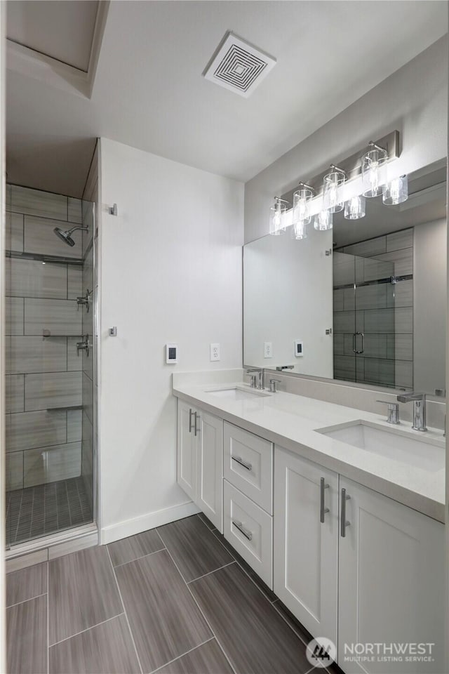 23120 SE Black Nugget Rd Unit A2, Issaquah, WA 98029 - bathroom featuring a stall shower, baseboards, and double vanity
