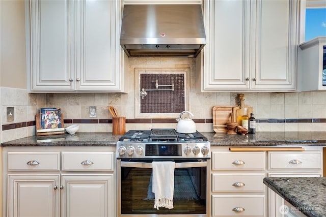 3212 Maplewood Cir NE, Tacoma, WA 98422 - kitchen featuring under cabinet range hood, gas stove, decorative backsplash, white cabinets, and dark stone counters