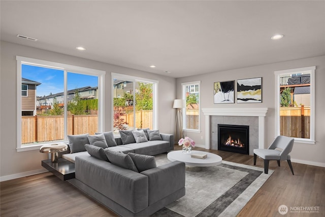 7627 10th St SE, Lake Stevens, WA 98258 - living room featuring a tiled fireplace, recessed lighting, baseboards, and wood finished floors
