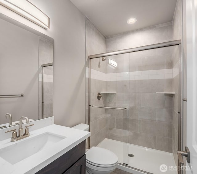 7627 10th St SE, Lake Stevens, WA 98258 - bathroom with a shower stall, toilet, vanity, and recessed lighting