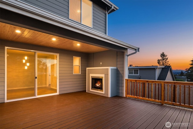7627 10th St SE, Lake Stevens, WA 98258 - wooden deck featuring a warm lit fireplace