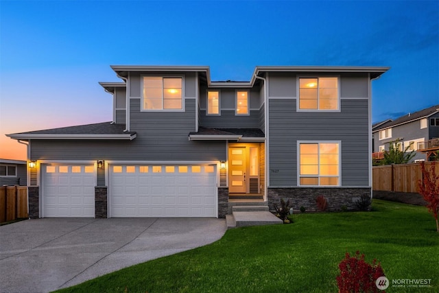 7627 10th St SE, Lake Stevens, WA 98258 - view of front of home featuring stone siding, concrete driveway, and a garage