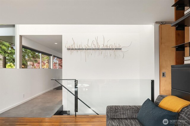 hallway featuring wood finished floors and baseboards