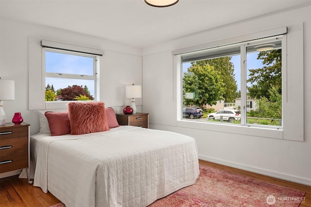 bedroom featuring wood finished floors and baseboards