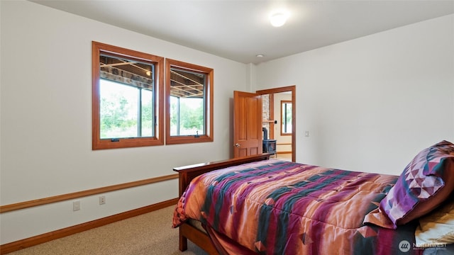 bedroom with multiple windows, carpet floors, and baseboards