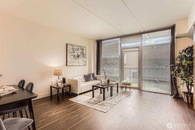 2911 2nd Ave Unit 513, Seattle, WA 98121 - living area with expansive windows, dark wood finished floors, and baseboards