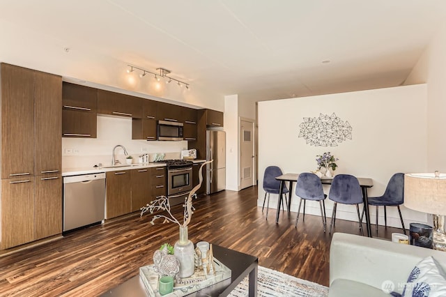 2911 2nd Ave Unit 513, Seattle, WA 98121 - living area featuring dark wood finished floors and rail lighting