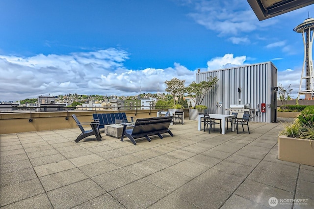 2911 2nd Ave Unit 513, Seattle, WA 98121 - view of patio / terrace with outdoor dining space and an outdoor fire pit