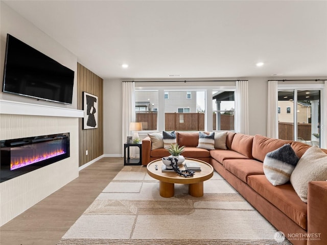 11455 SE 84th St Unit 43, Newcastle, WA 98056 - living area featuring wood finished floors, a glass covered fireplace, and recessed lighting