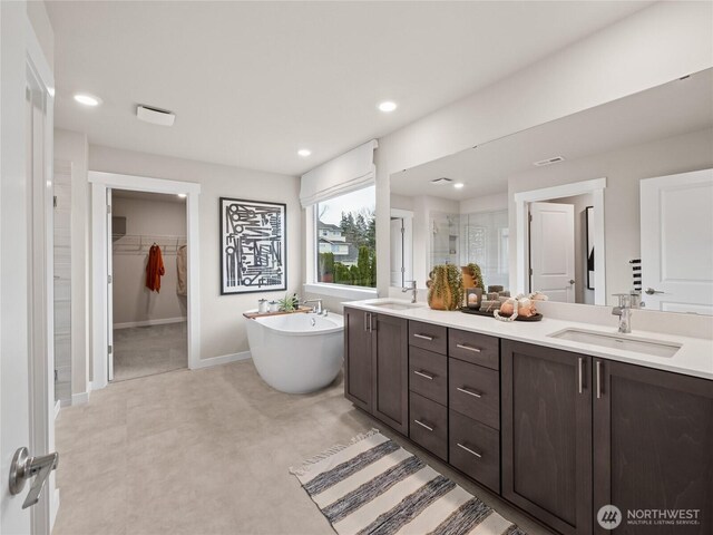 11455 SE 84th St Unit 43, Newcastle, WA 98056 - bathroom with a shower stall, double vanity, a freestanding tub, a walk in closet, and recessed lighting