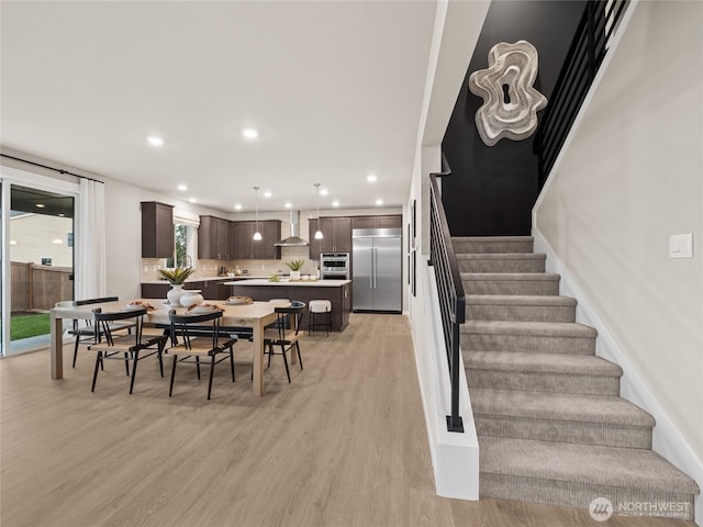 11455 SE 84th St Unit 43, Newcastle, WA 98056 - dining space with stairway, light wood finished floors, and recessed lighting