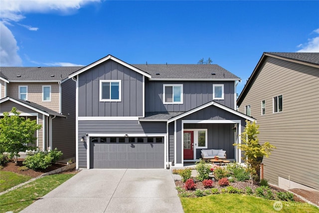 view of front of home featuring board and batten siding, concrete driveway, a garage, and covered porch
