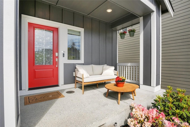 doorway to property featuring board and batten siding and covered porch