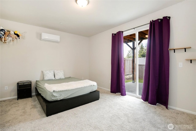 carpeted bedroom with a wall mounted AC, access to exterior, and baseboards