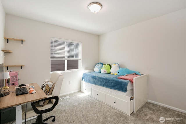 bedroom featuring carpet, an office area, and baseboards