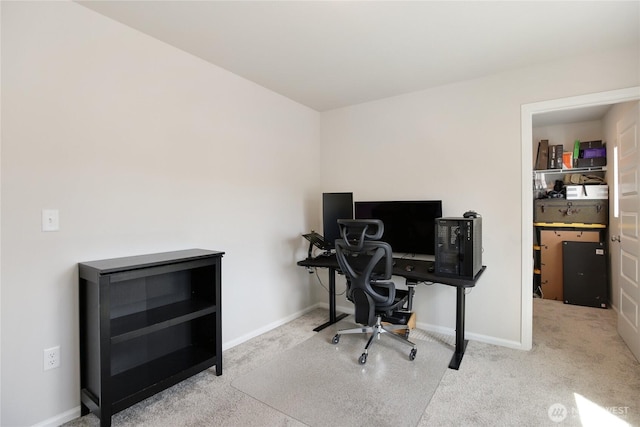 carpeted home office featuring baseboards