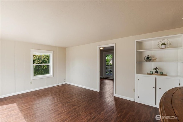 3270 Pine St, Longview, WA 98632 - unfurnished room with healthy amount of natural light, dark wood-style flooring, and built in shelves