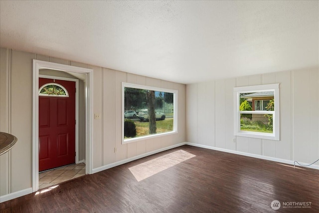 3270 Pine St, Longview, WA 98632 - foyer featuring wood finished floors, plenty of natural light, a decorative wall, and a textured ceiling