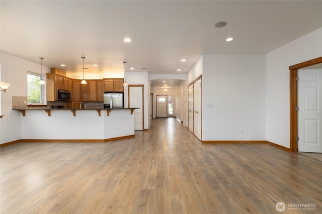 997 Chestnut Loop, Mount Vernon, WA 98273 - unfurnished living room with recessed lighting, wood finished floors, and baseboards