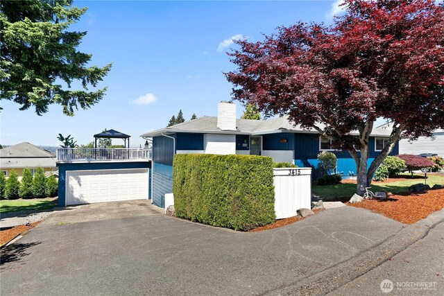 3415 Garden Ave N, Renton, WA 98056 - ranch-style house featuring a chimney, a garage, driveway, and a balcony