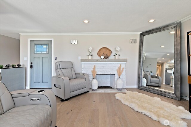 3415 Garden Ave N, Renton, WA 98056 - living room with ornamental molding, wood finished floors, a stone fireplace, and recessed lighting