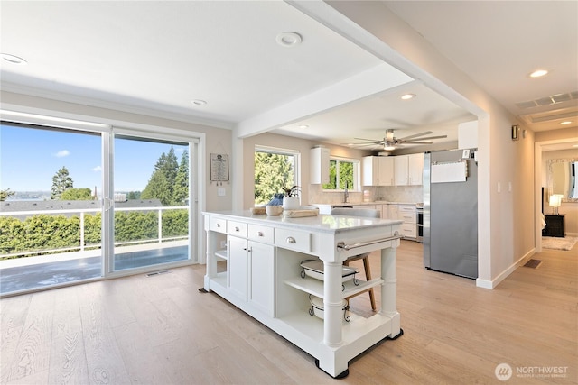 3415 Garden Ave N, Renton, WA 98056 - kitchen featuring open shelves, freestanding refrigerator, light wood finished floors, recessed lighting, and white cabinetry