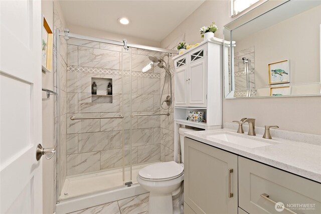 3415 Garden Ave N, Renton, WA 98056 - bathroom with toilet, a shower stall, vanity, marble look tile flooring, and recessed lighting