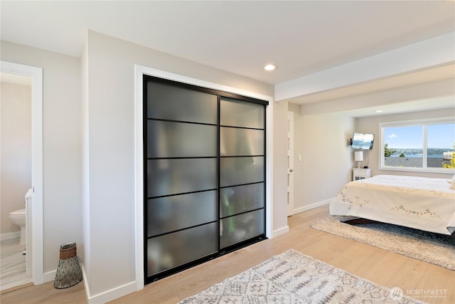 3415 Garden Ave N, Renton, WA 98056 - bedroom featuring wood finished floors, baseboards, ensuite bathroom, and recessed lighting
