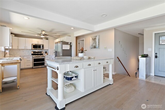 3415 Garden Ave N, Renton, WA 98056 - kitchen featuring appliances with stainless steel finishes, open shelves, light wood-style floors, recessed lighting, and white cabinets