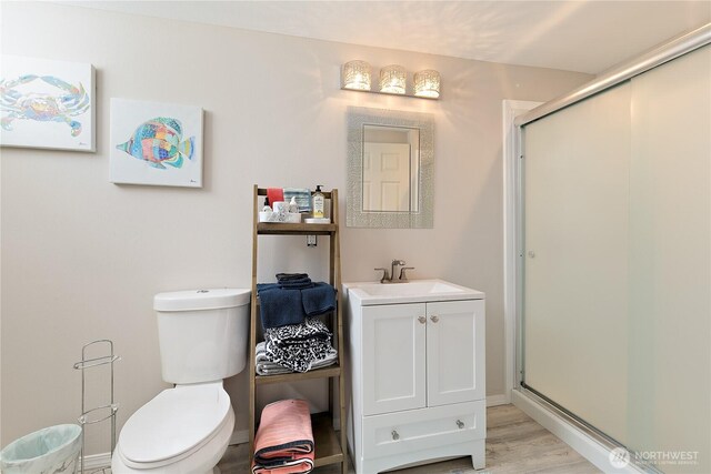 3415 Garden Ave N, Renton, WA 98056 - bathroom featuring a shower stall, vanity, wood finished floors, and toilet
