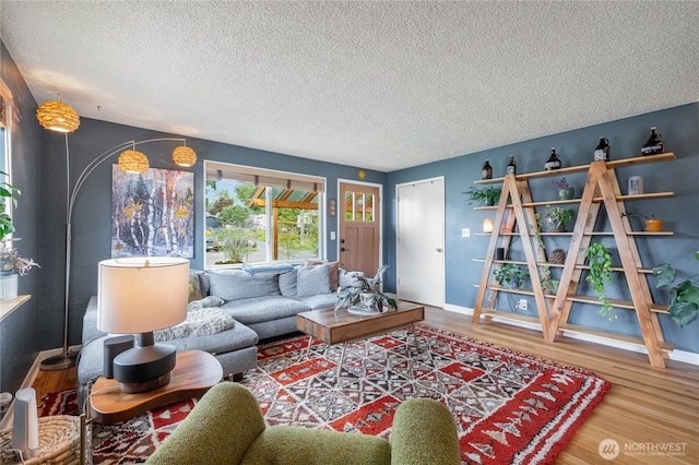 11008 2nd Ave S, Seattle, WA 98168 - living room featuring wood finished floors, baseboards, and a textured ceiling