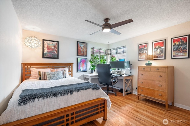 11008 2nd Ave S, Seattle, WA 98168 - bedroom with a textured ceiling, wood finished floors, a chandelier, baseboards, and ceiling fan