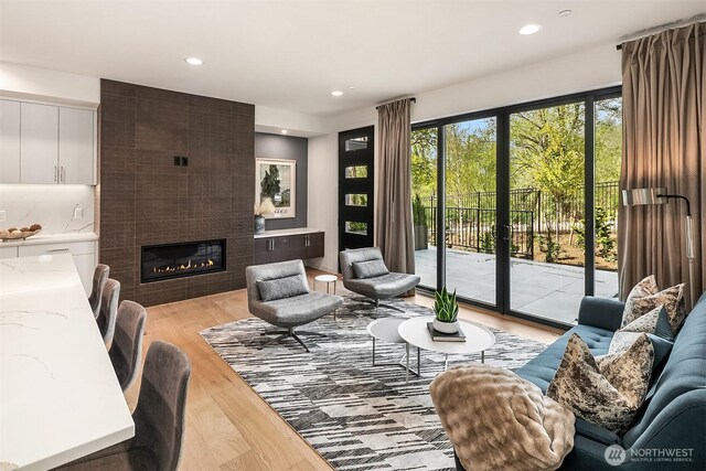 290 118th Ave SE, Bellevue, WA 98005 - living area featuring a tiled fireplace, light wood-style floors, and recessed lighting