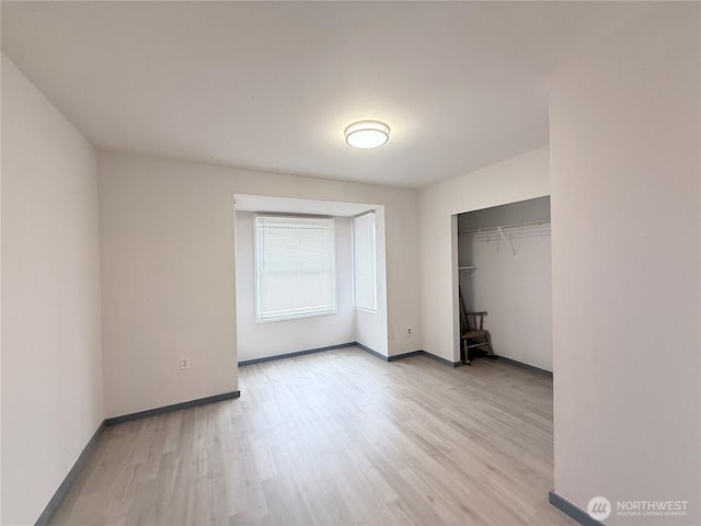 328 S Division St, Auburn, WA 98001 - unfurnished bedroom with light wood-type flooring, a closet, and baseboards
