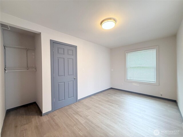 328 S Division St, Auburn, WA 98001 - unfurnished bedroom featuring a closet, light wood finished floors, and baseboards
