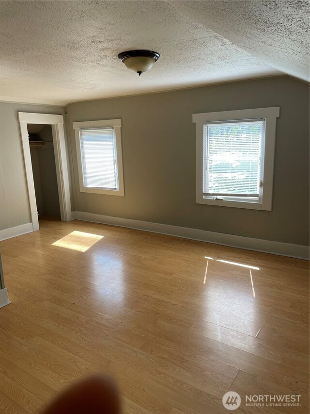 328 S Division St, Auburn, WA 98001 - unfurnished room with a textured ceiling, baseboards, and wood finished floors
