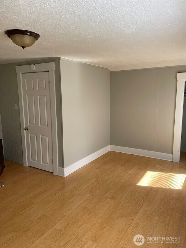 328 S Division St, Auburn, WA 98001 - unfurnished room with a textured ceiling, light wood-style floors, and baseboards