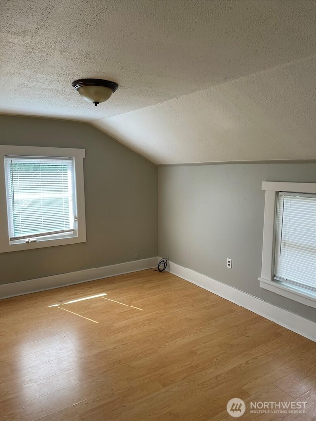 328 S Division St, Auburn, WA 98001 - additional living space featuring a textured ceiling, vaulted ceiling, wood finished floors, and baseboards