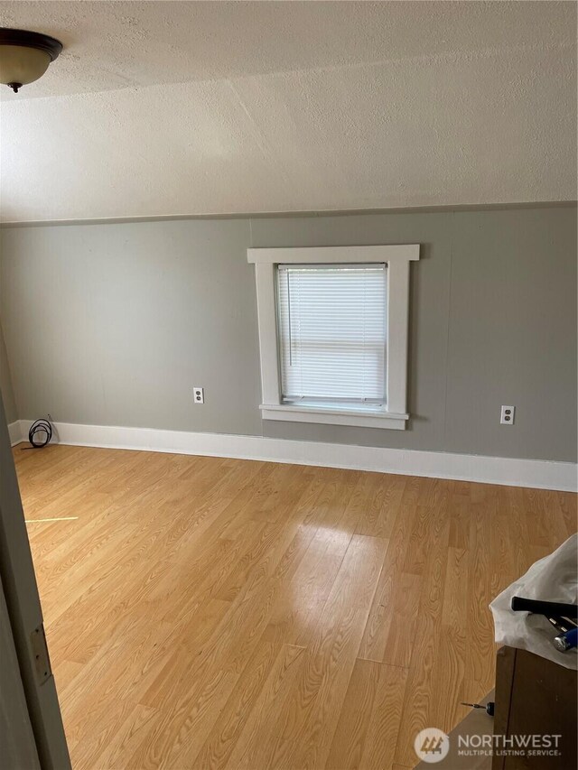 328 S Division St, Auburn, WA 98001 - empty room featuring wood finished floors, a textured ceiling, and baseboards