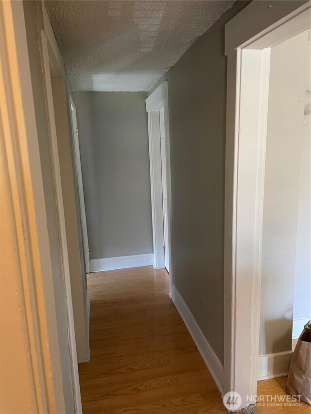 328 S Division St, Auburn, WA 98001 - corridor featuring a textured ceiling, wood finished floors, and baseboards