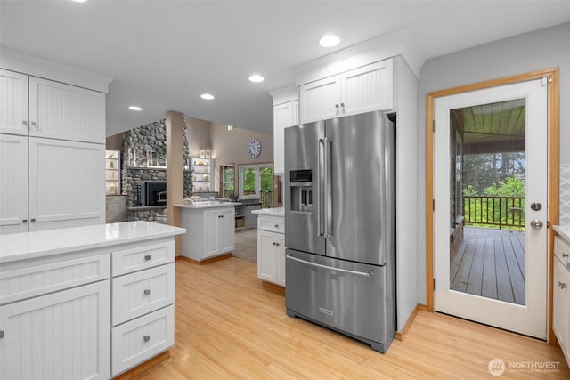 kitchen with stainless steel fridge, plenty of natural light, light wood-style flooring, and recessed lighting