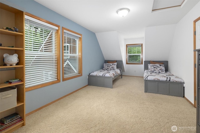 bedroom featuring carpet floors, attic access, vaulted ceiling, and baseboards