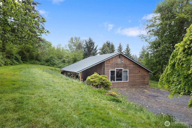 view of side of home with a yard