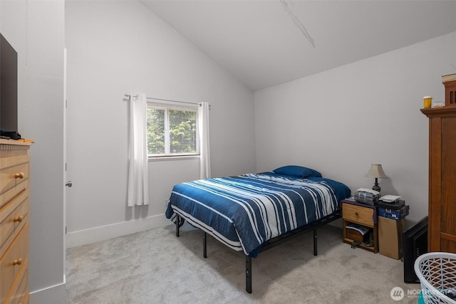 bedroom with carpet flooring, lofted ceiling, and baseboards