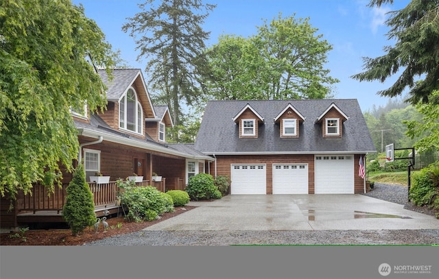view of front of home featuring driveway and roof with shingles