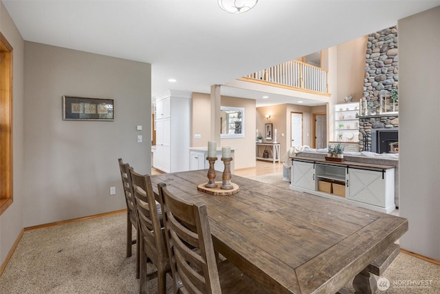 dining area with light colored carpet, baseboards, recessed lighting, and a fireplace
