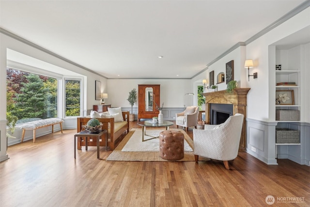 16255 38th Ave NE, Lake Forest Park, WA 98155 - living area featuring plenty of natural light, light wood finished floors, a fireplace, ornamental molding, and a decorative wall