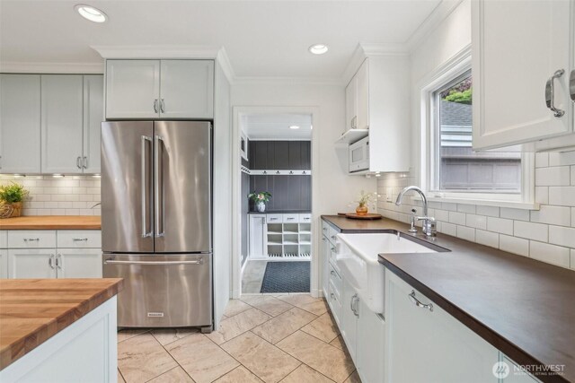 16255 38th Ave NE, Lake Forest Park, WA 98155 - kitchen featuring high end fridge, butcher block counters, decorative backsplash, white microwave, and recessed lighting